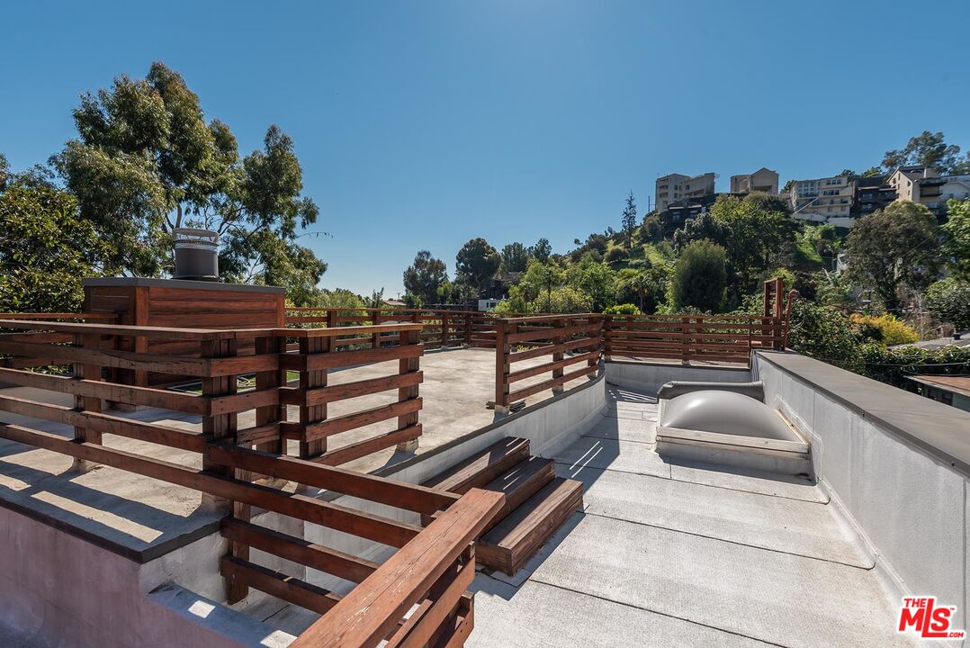 8544 Ridpath Drive West Hollywood, CA 90046 - Photo 32 of 34 a view of a balcony with two chairs and a potted plant