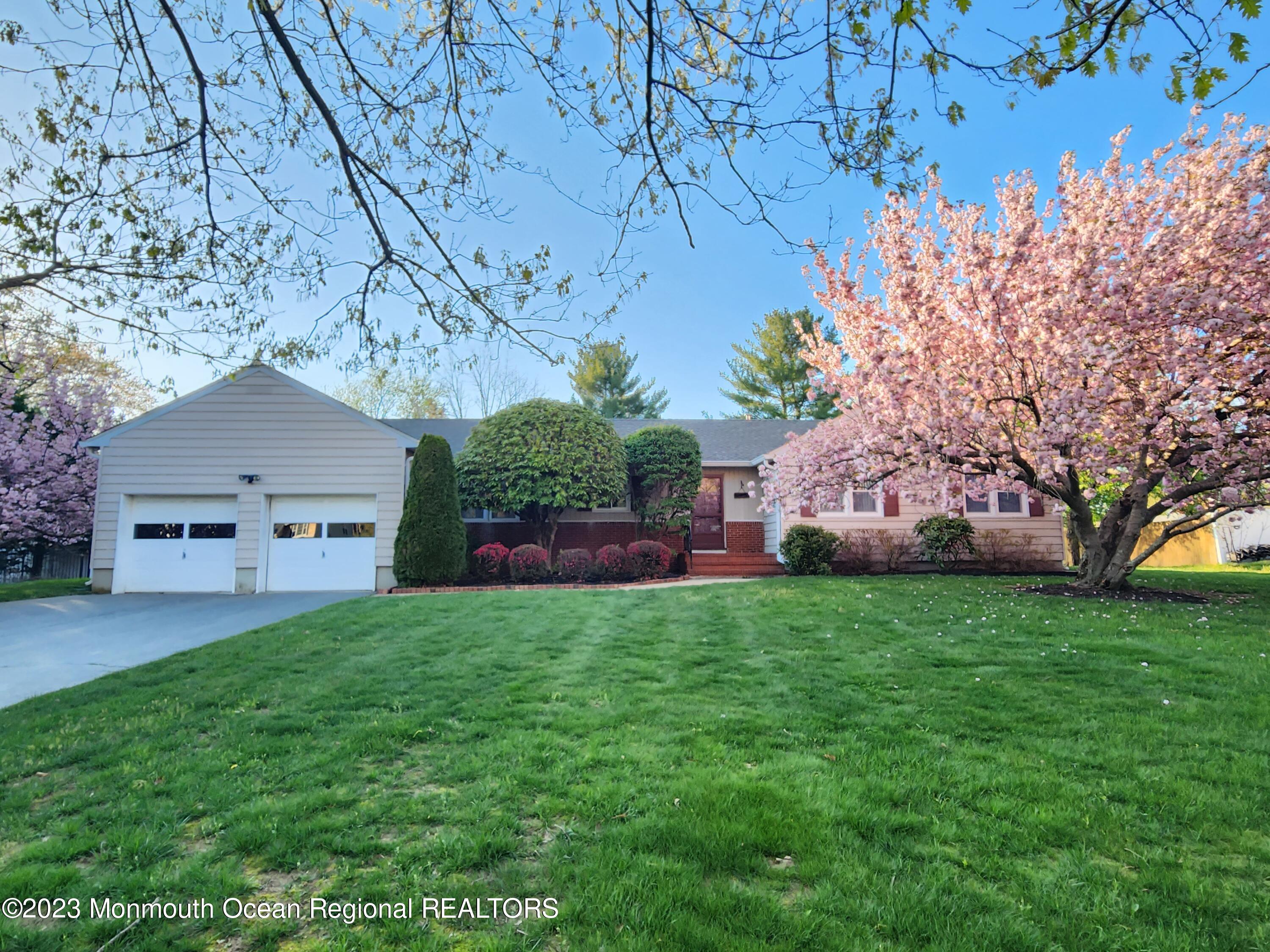11 Woods Road Freehold, NJ 07728 - Photo 1 of 25 a front view of a house with garden