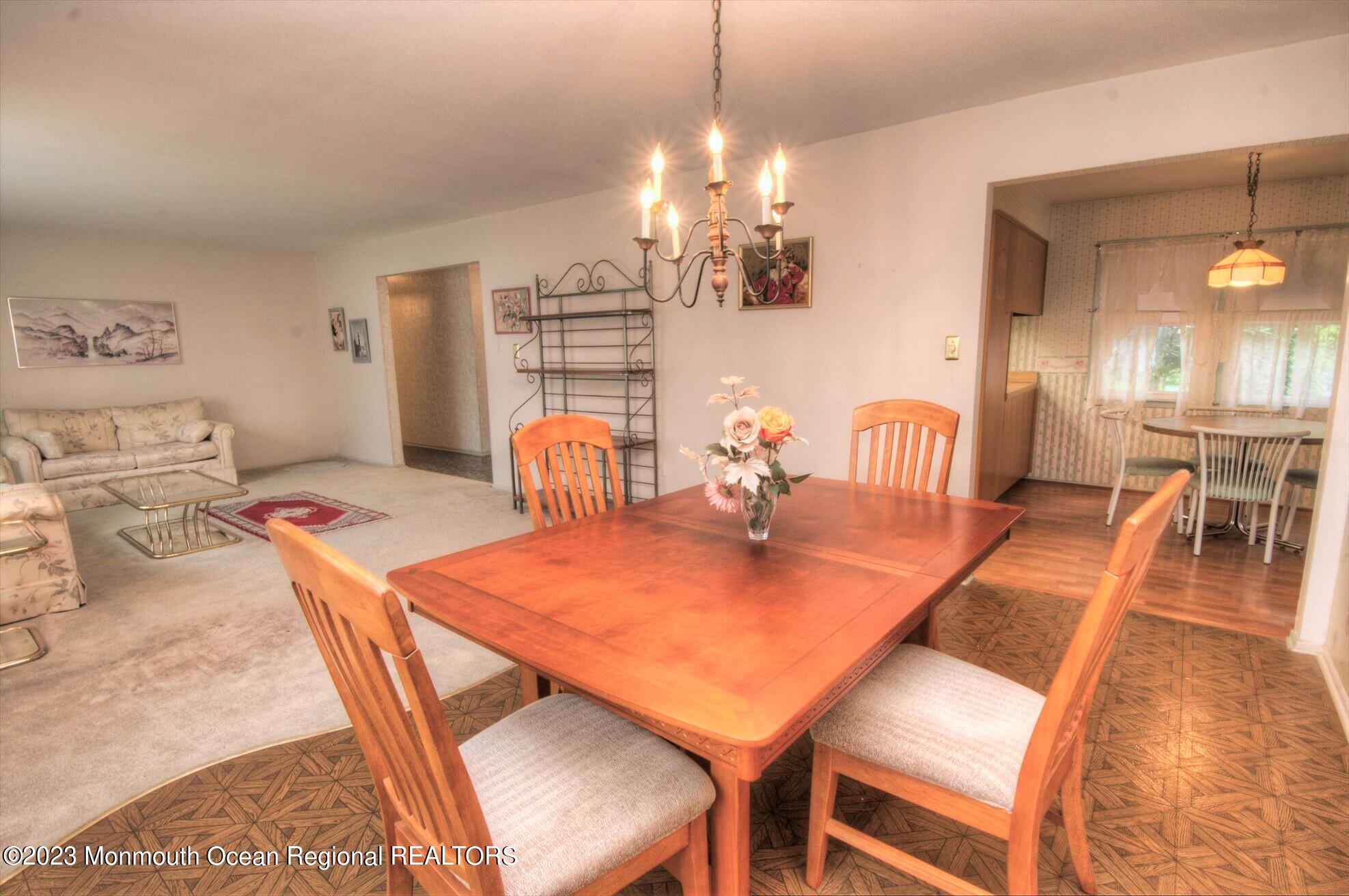 11 Woods Road Freehold, NJ 07728 - Photo 11 of 25 a view of a dining room with furniture and wooden floor