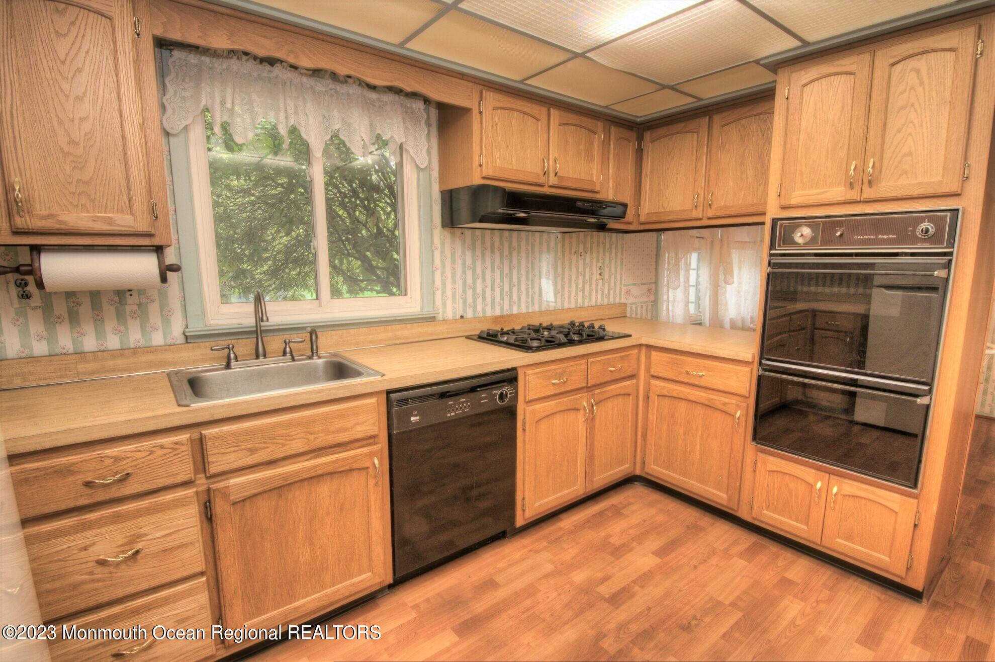 11 Woods Road Freehold, NJ 07728 - Photo 12 of 25 a kitchen with stainless steel appliances granite countertop a sink stove and refrigerator