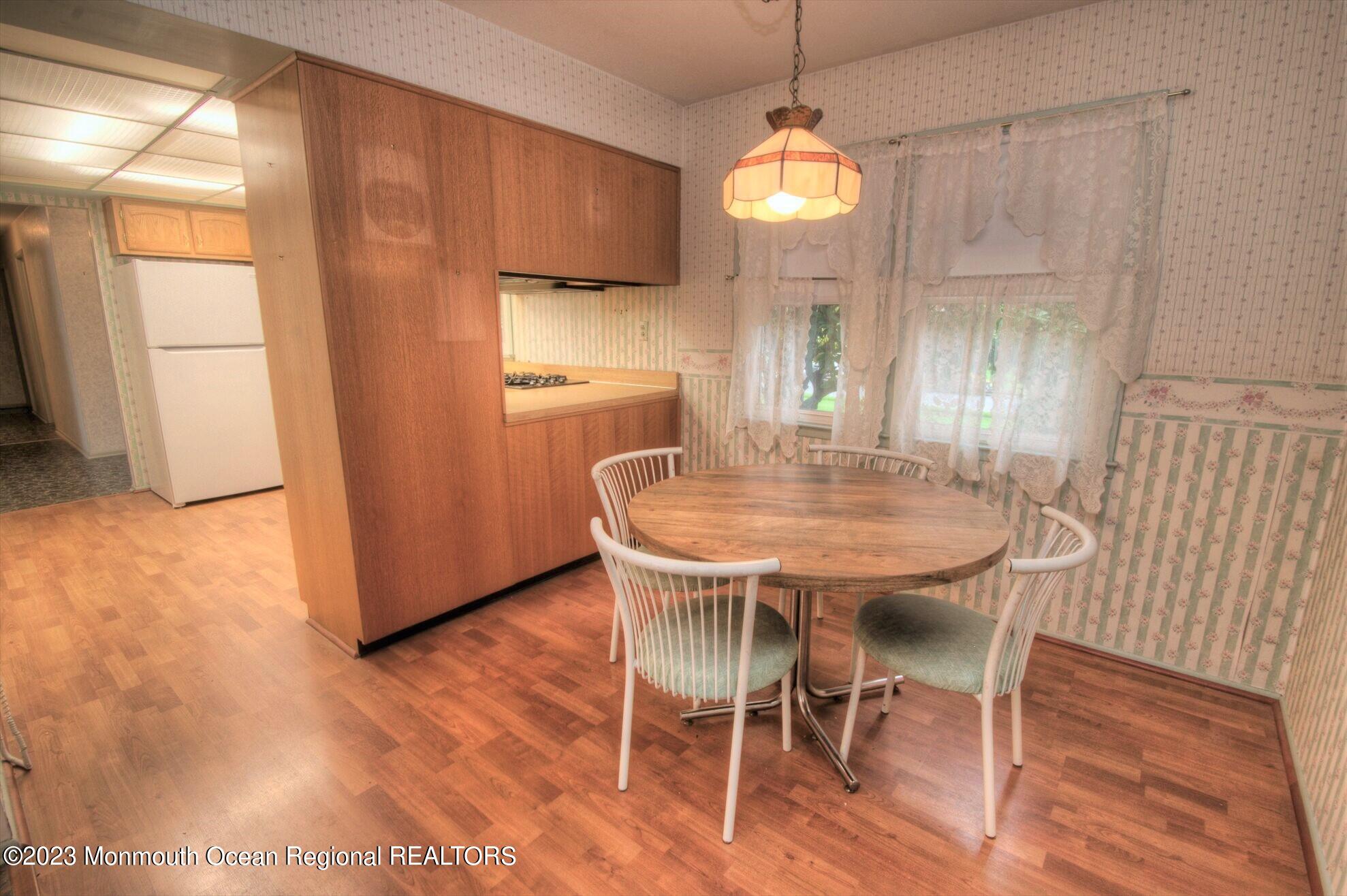 11 Woods Road Freehold, NJ 07728 - Photo 14 of 25 a view of a dining room with furniture window and wooden floor
