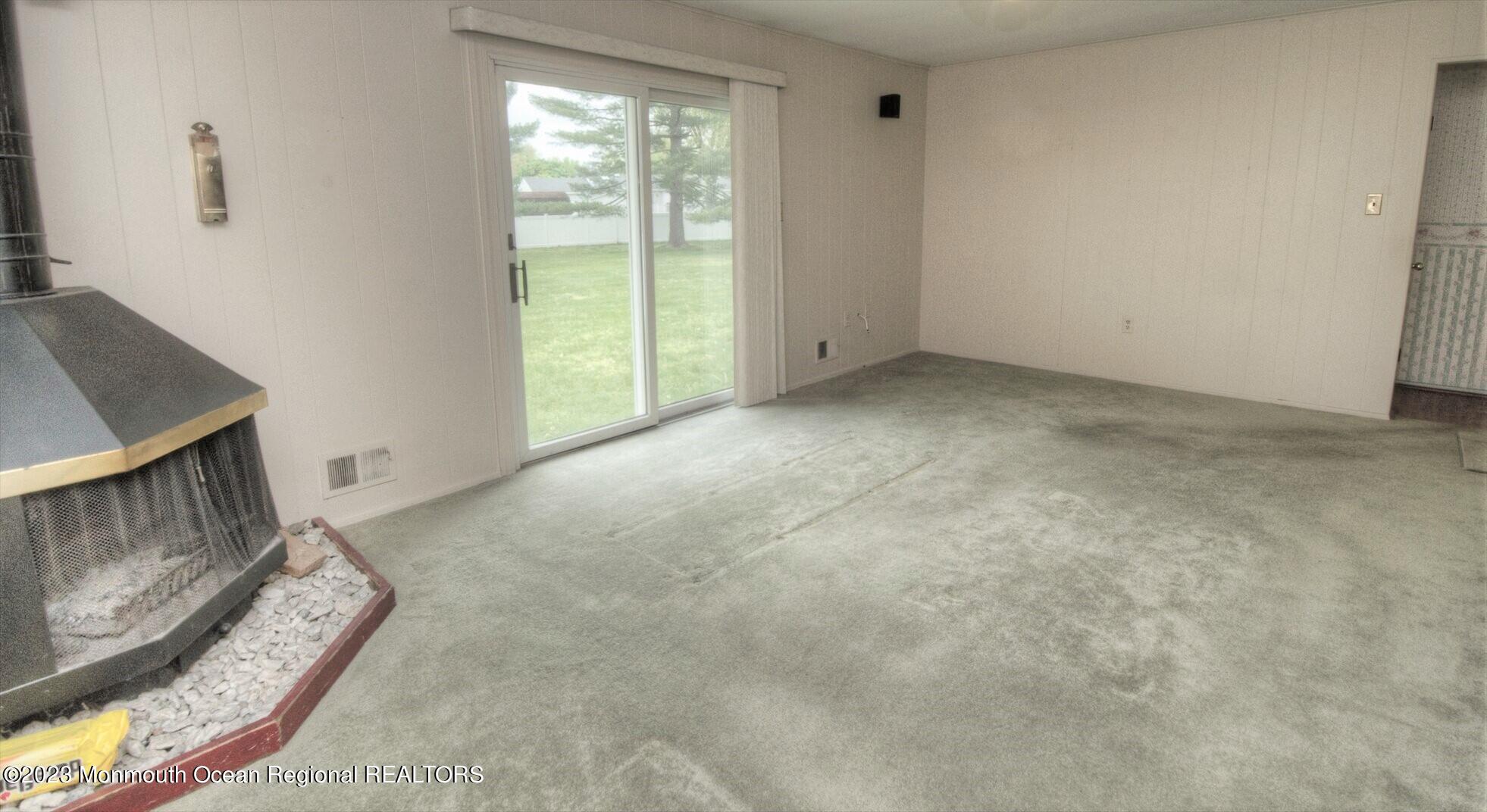 11 Woods Road Freehold, NJ 07728 - Photo 15 of 25 a view of an empty room with wooden floor and a window