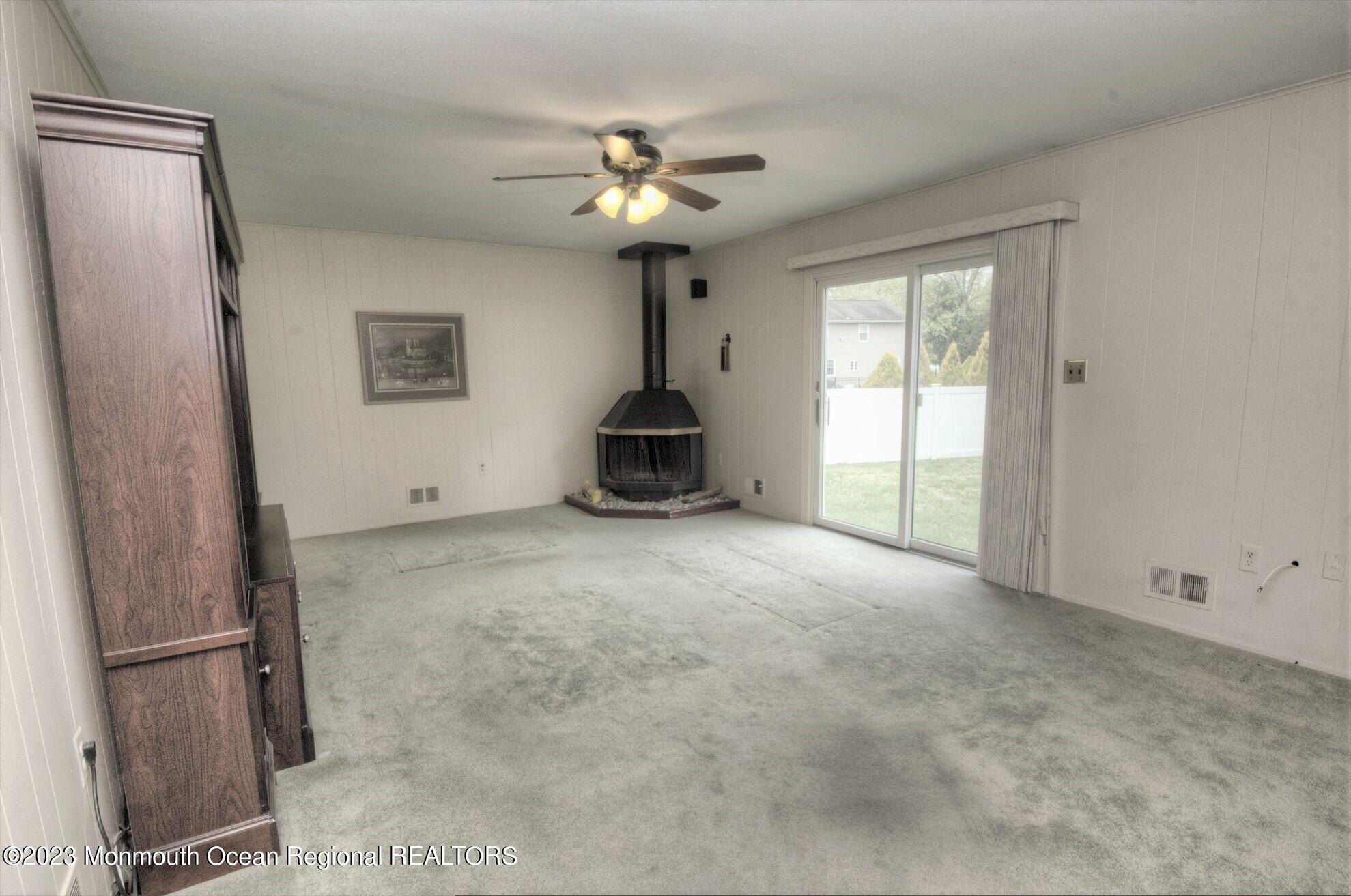 11 Woods Road Freehold, NJ 07728 - Photo 16 of 25 a view of a livingroom with a chandelier fan and windows