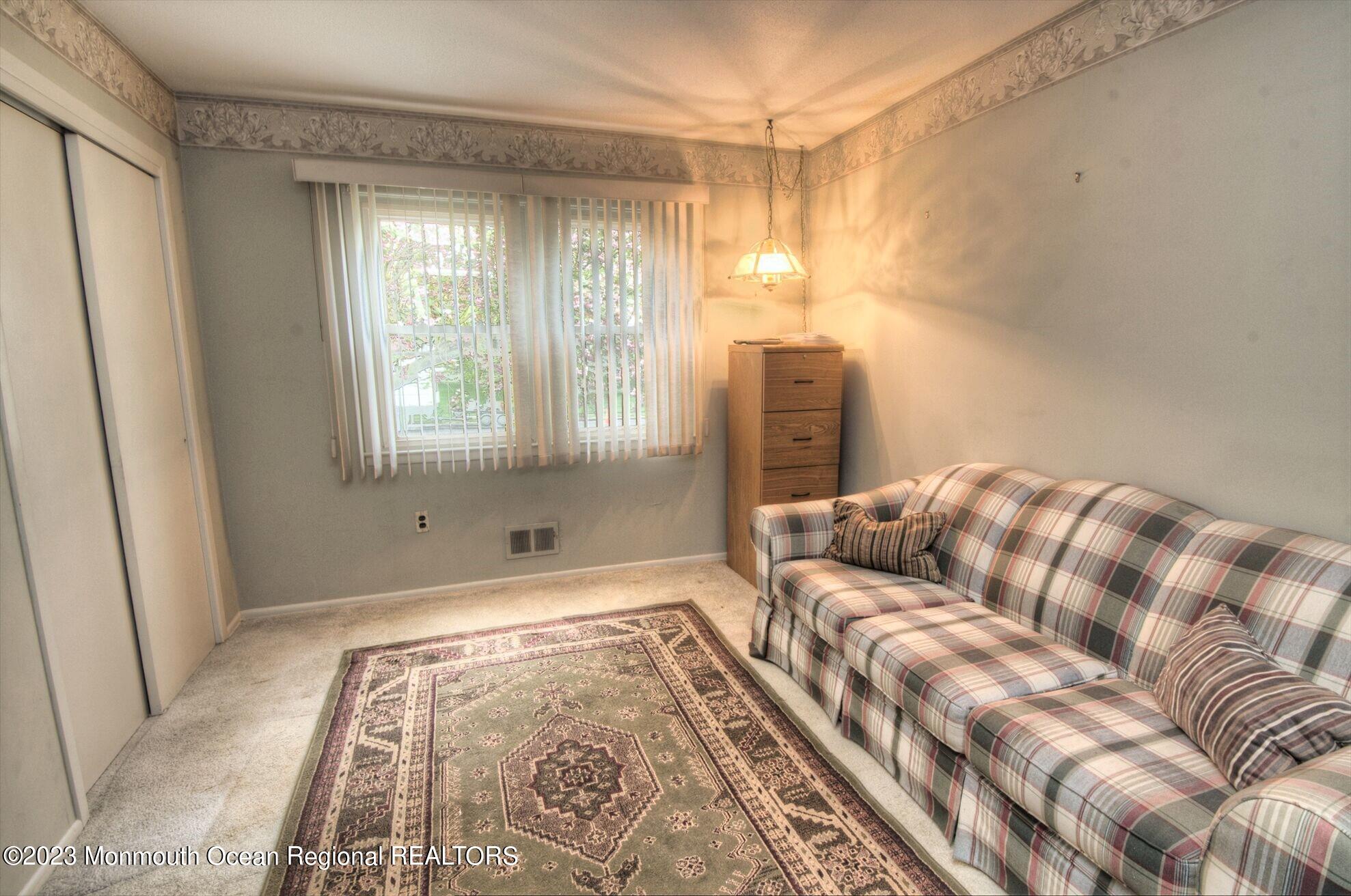 11 Woods Road Freehold, NJ 07728 - Photo 18 of 25 a bedroom with a bed and a window