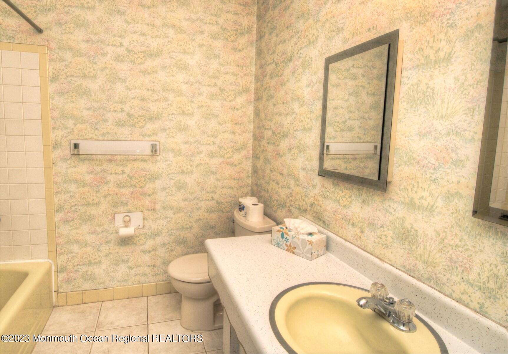 11 Woods Road Freehold, NJ 07728 - Photo 19 of 25 a bathroom with a granite countertop toilet a sink and mirror
