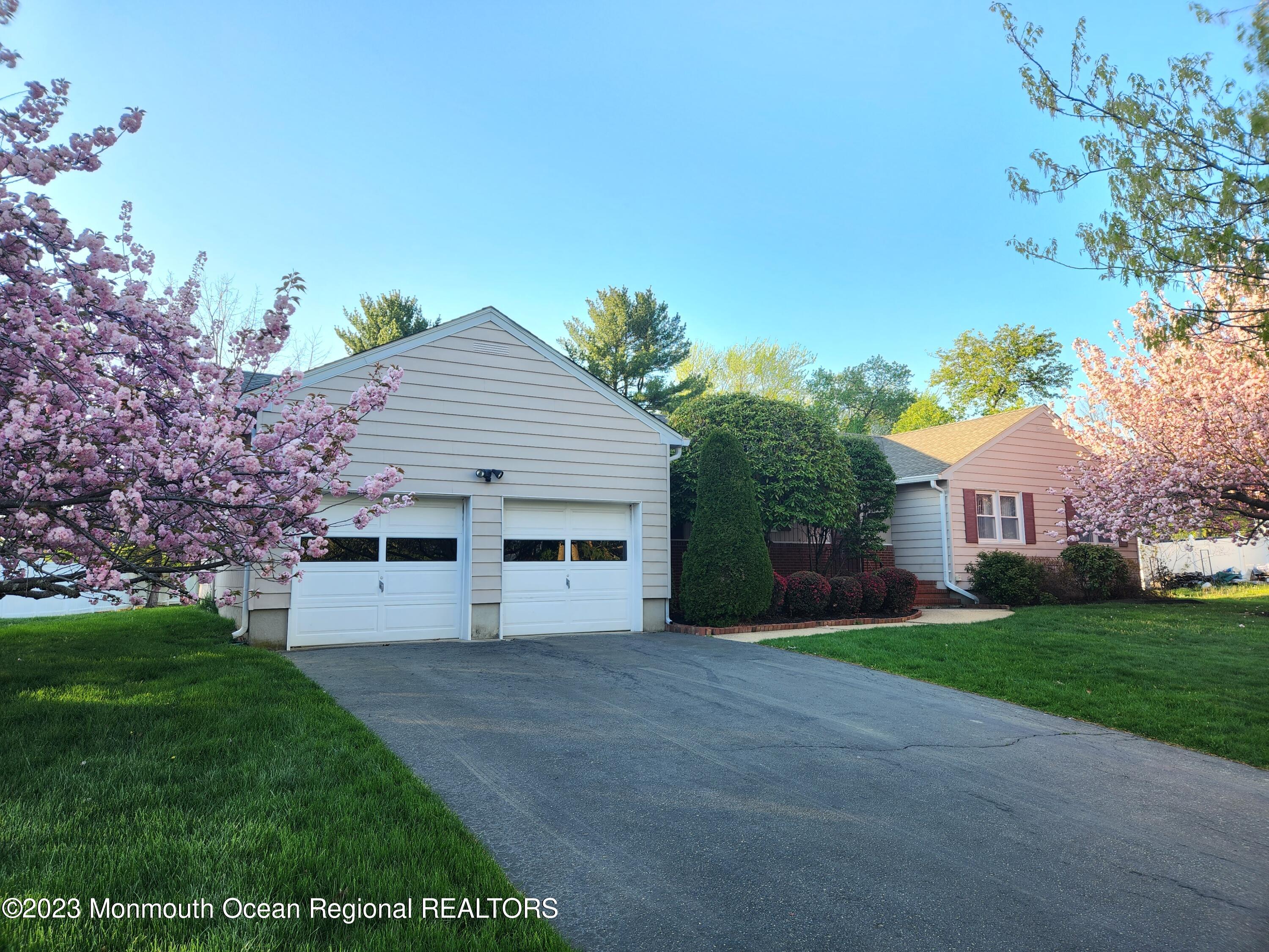 11 Woods Road Freehold, NJ 07728 - Photo 2 of 25 a view of a house with a yard and potted plants