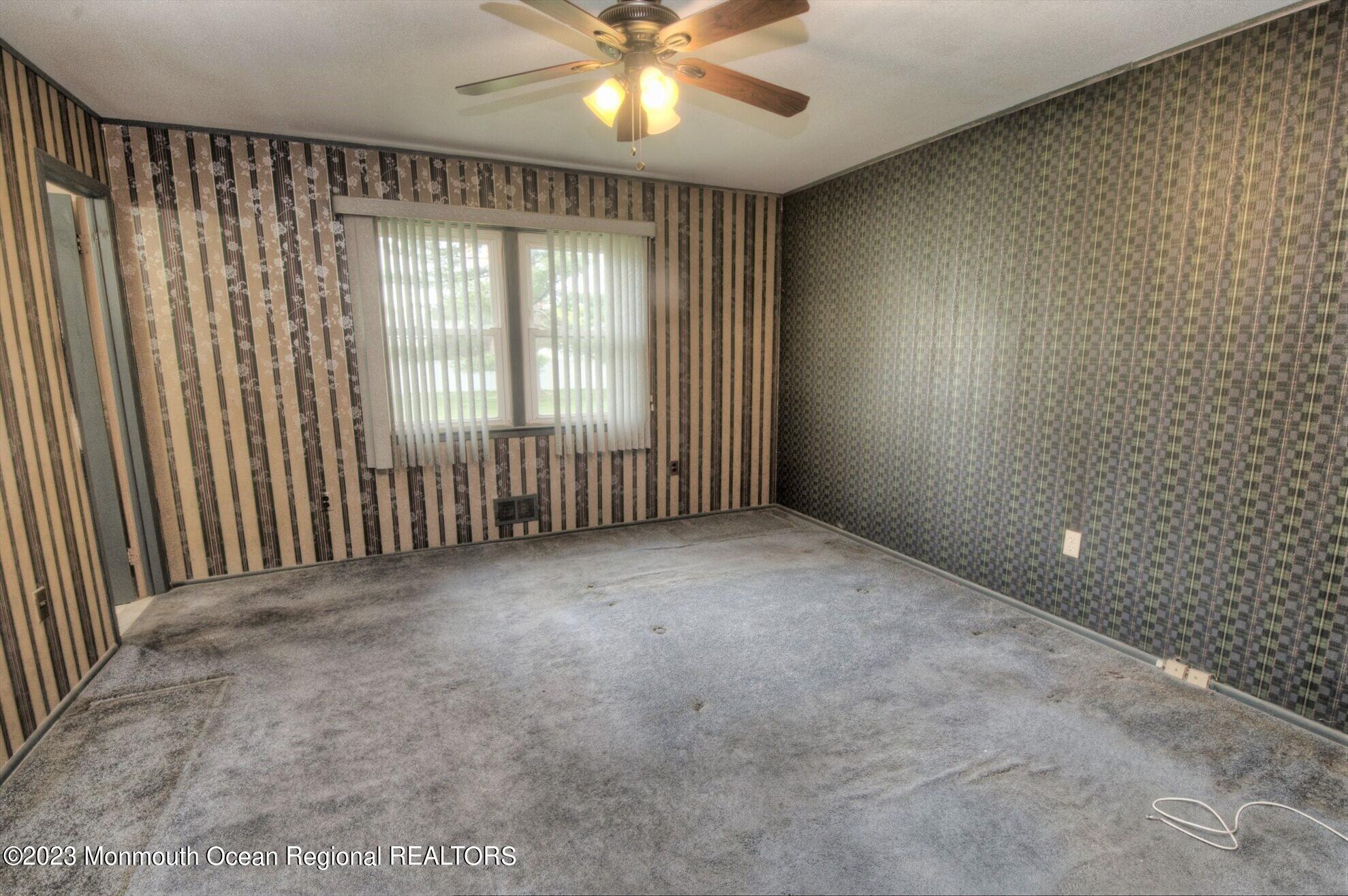11 Woods Road Freehold, NJ 07728 - Photo 21 of 25 an empty room with windows and chandelier fan