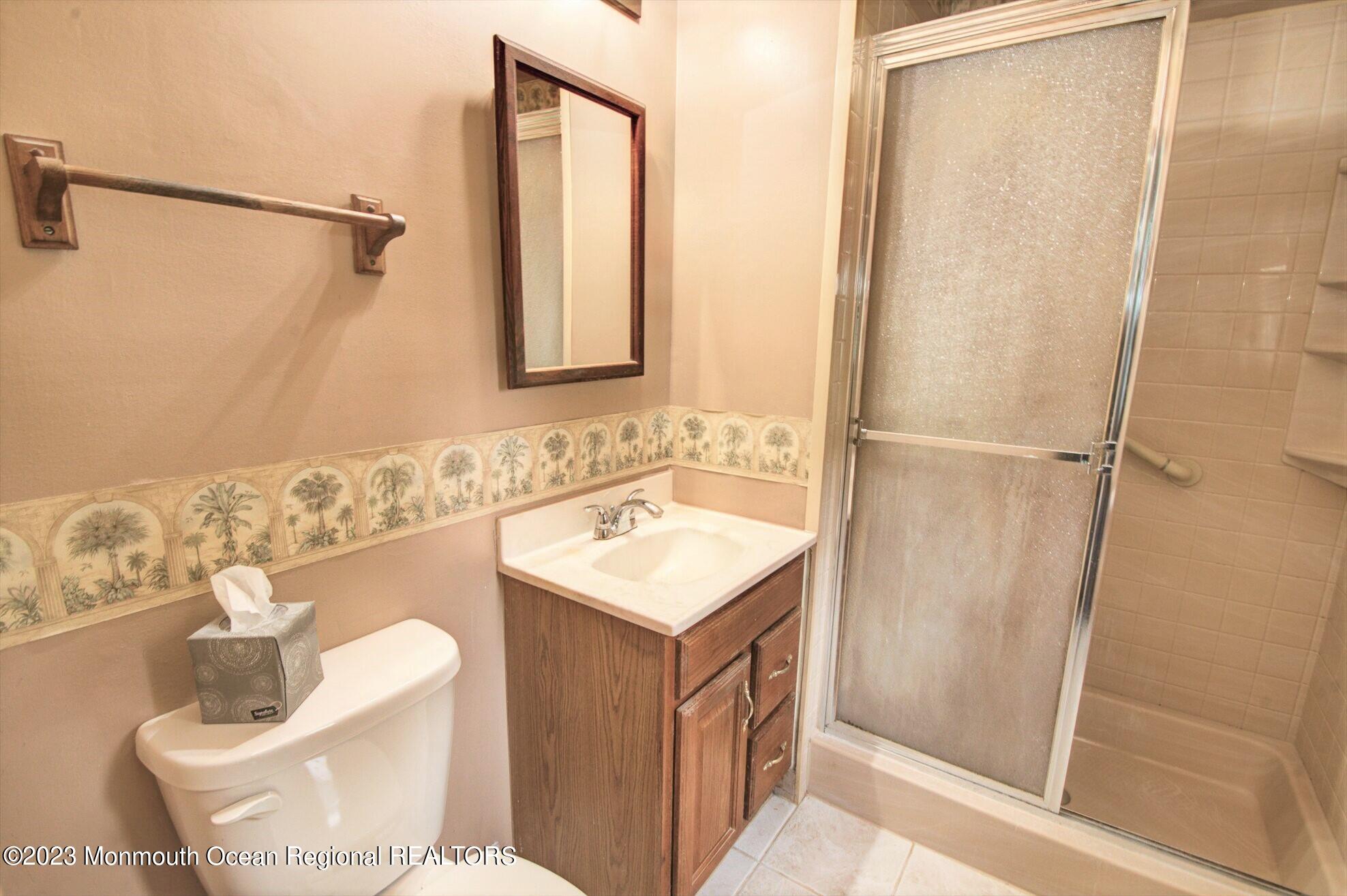 11 Woods Road Freehold, NJ 07728 - Photo 22 of 25 a bathroom with a sink toilet and shower
