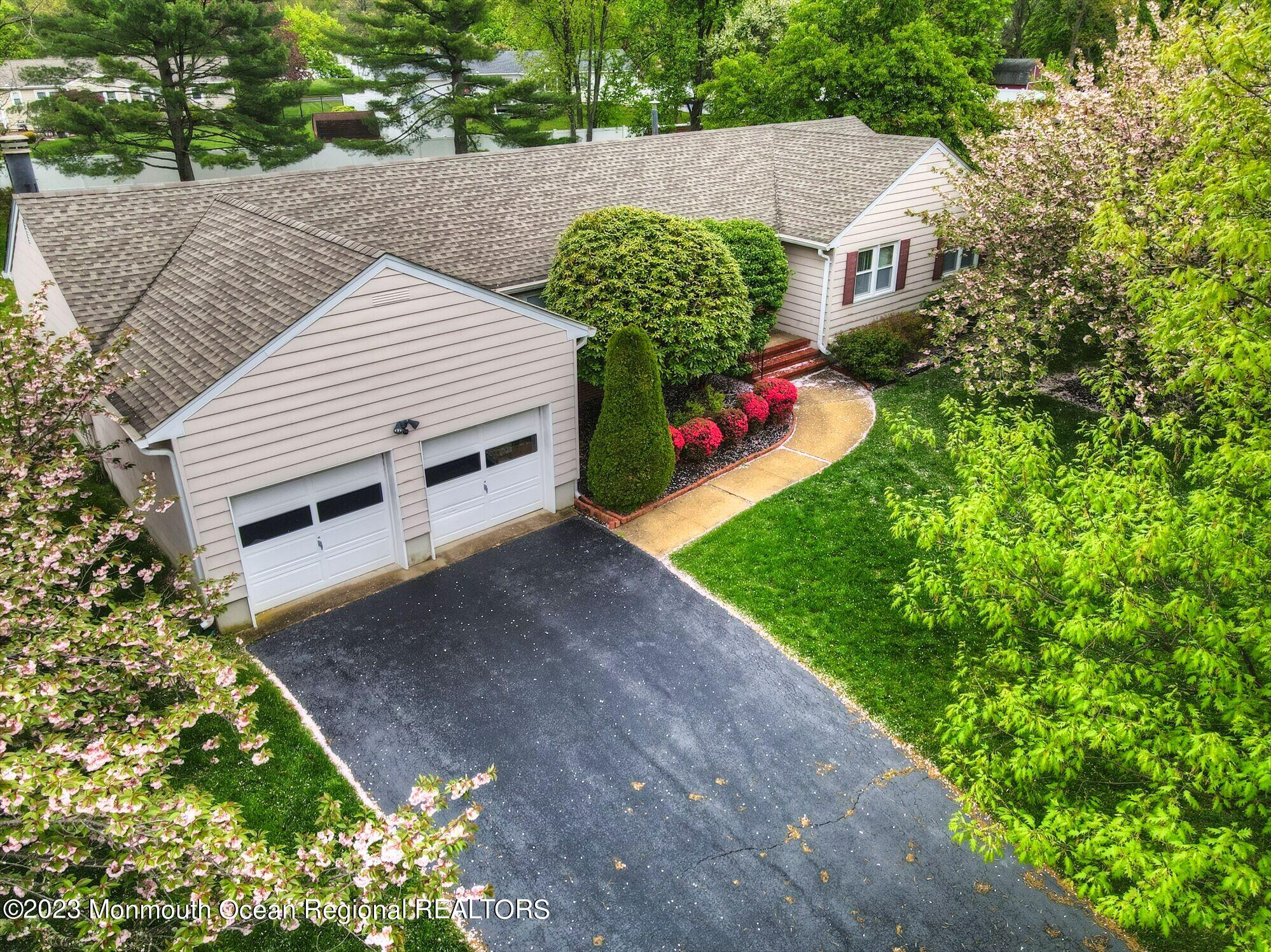 11 Woods Road Freehold, NJ 07728 - Photo 3 of 25 a view of a house with a yard and a garage