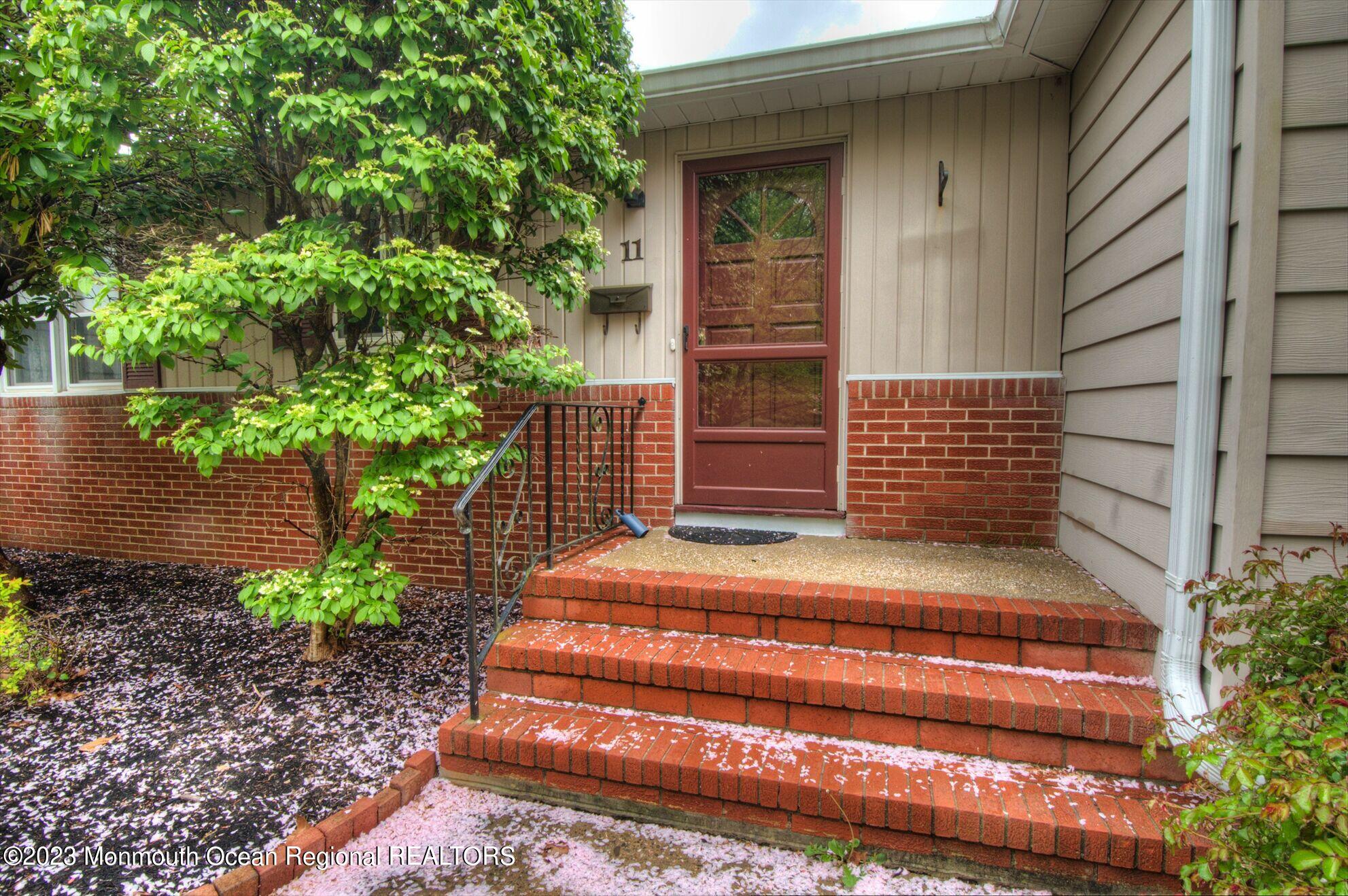 11 Woods Road Freehold, NJ 07728 - Photo 5 of 25 a yellow house with outdoor space