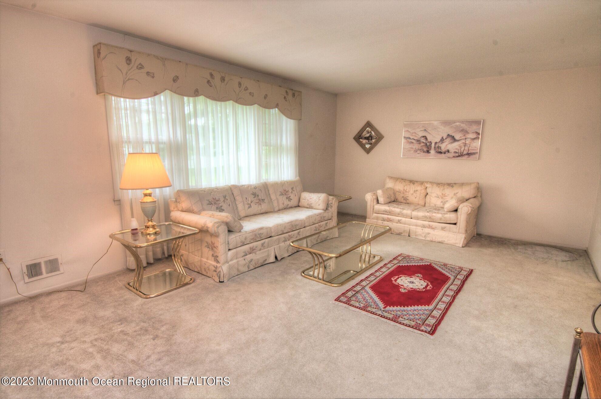 11 Woods Road Freehold, NJ 07728 - Photo 7 of 25 a living room with furniture and a window