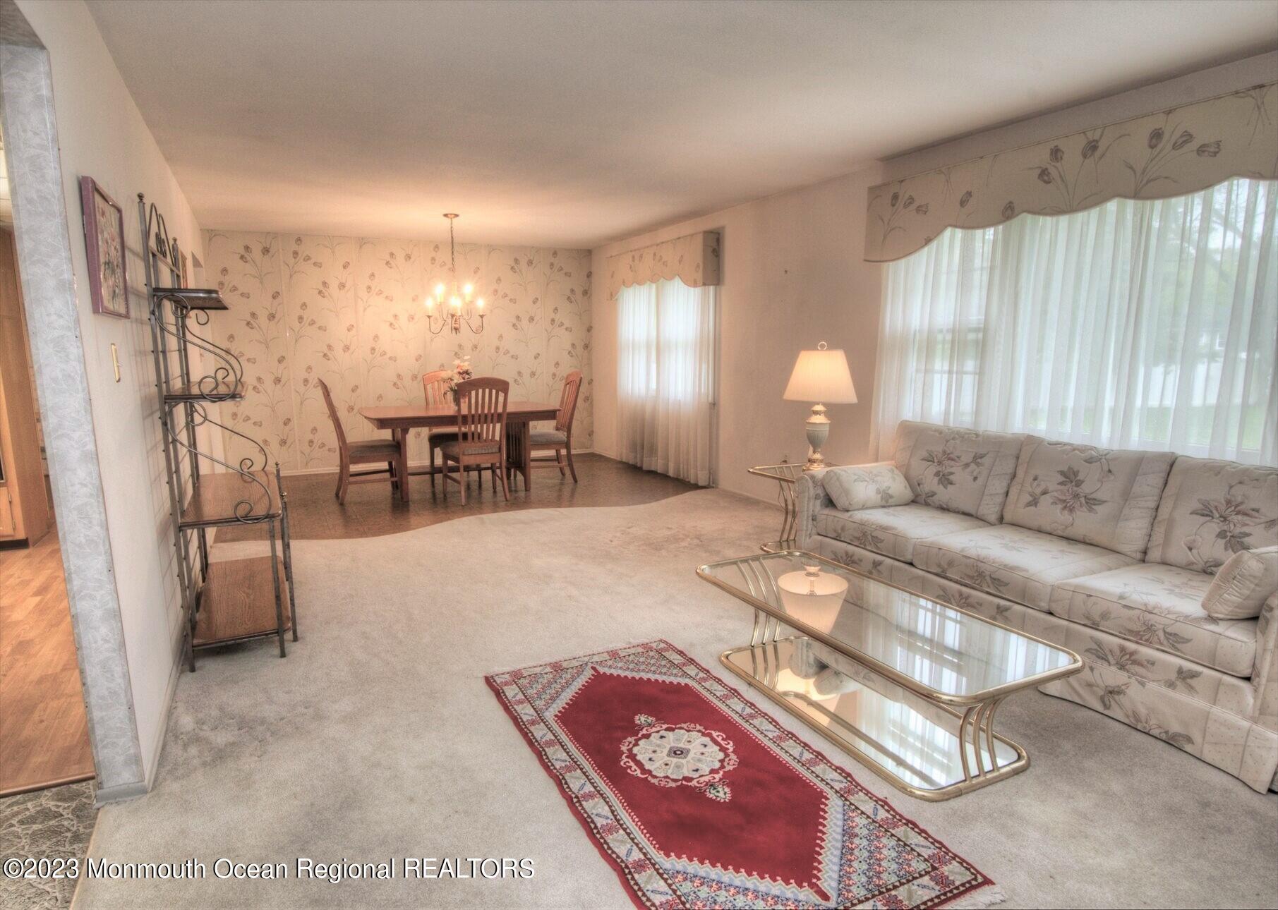 11 Woods Road Freehold, NJ 07728 - Photo 8 of 25 a living room with furniture a window and a table
