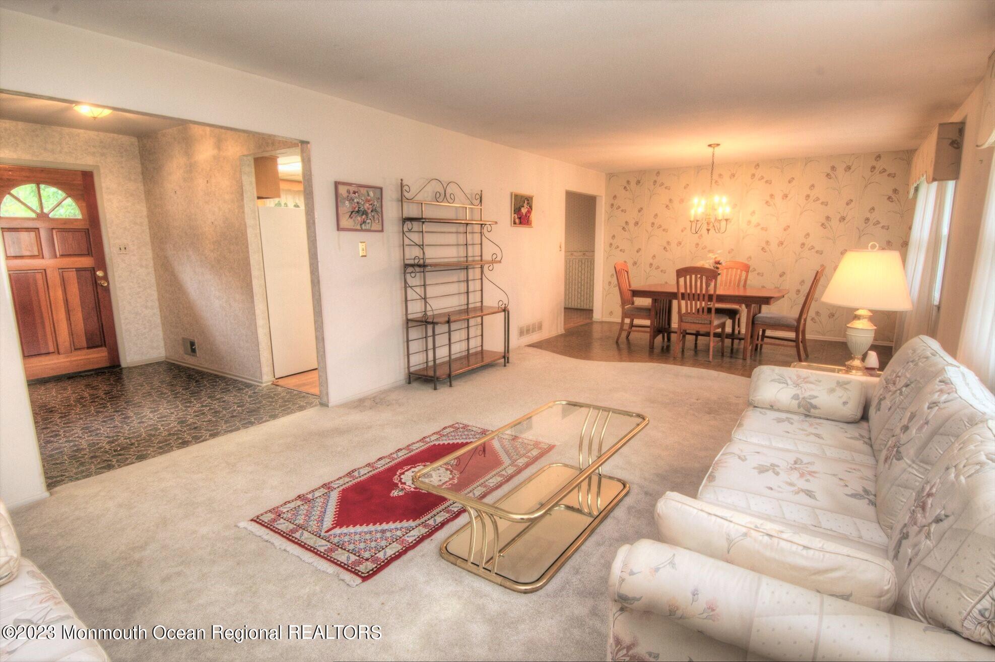 11 Woods Road Freehold, NJ 07728 - Photo 9 of 25 a living room with furniture and a large window