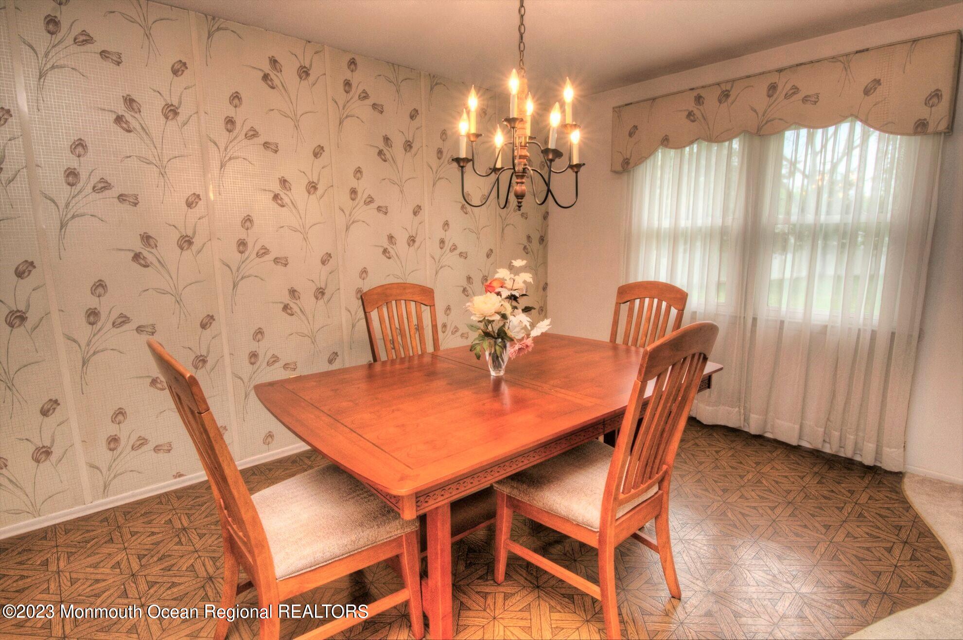 11 Woods Road Freehold, NJ 07728 - Photo 10 of 25 a dining room with furniture and chandelier kitchen view