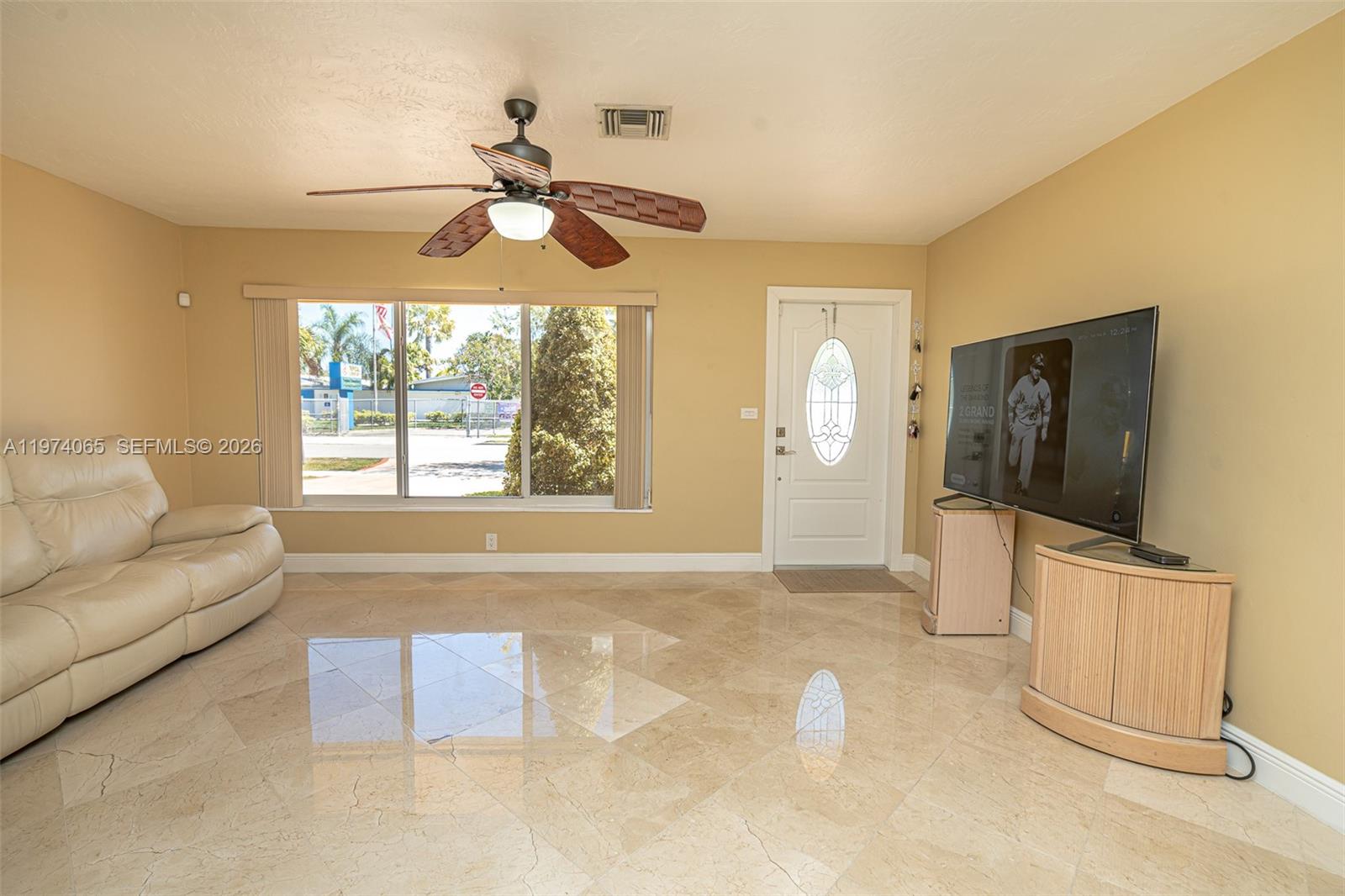 4600 Southwest 104th Avenue Miami, FL 33165 - Photo 16 of 40 a living room with furniture and a flat screen tv