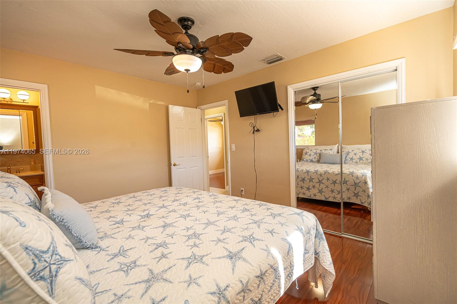 4600 Southwest 104th Avenue Miami, FL 33165 - Photo 17 of 40 a bedroom with a bed and a chandelier