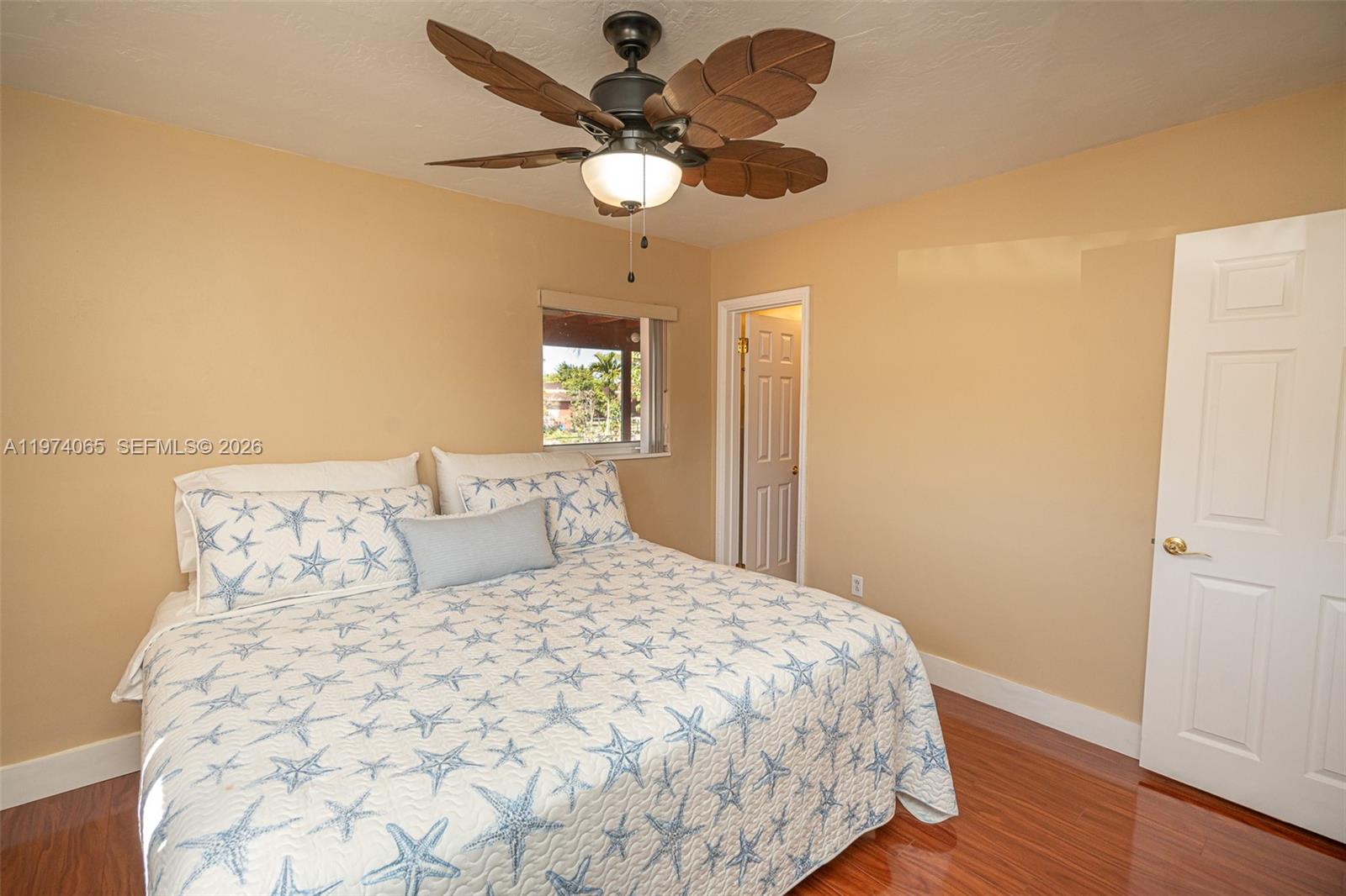 4600 Southwest 104th Avenue Miami, FL 33165 - Photo 18 of 40 a bedroom with a large bed and a chandelier