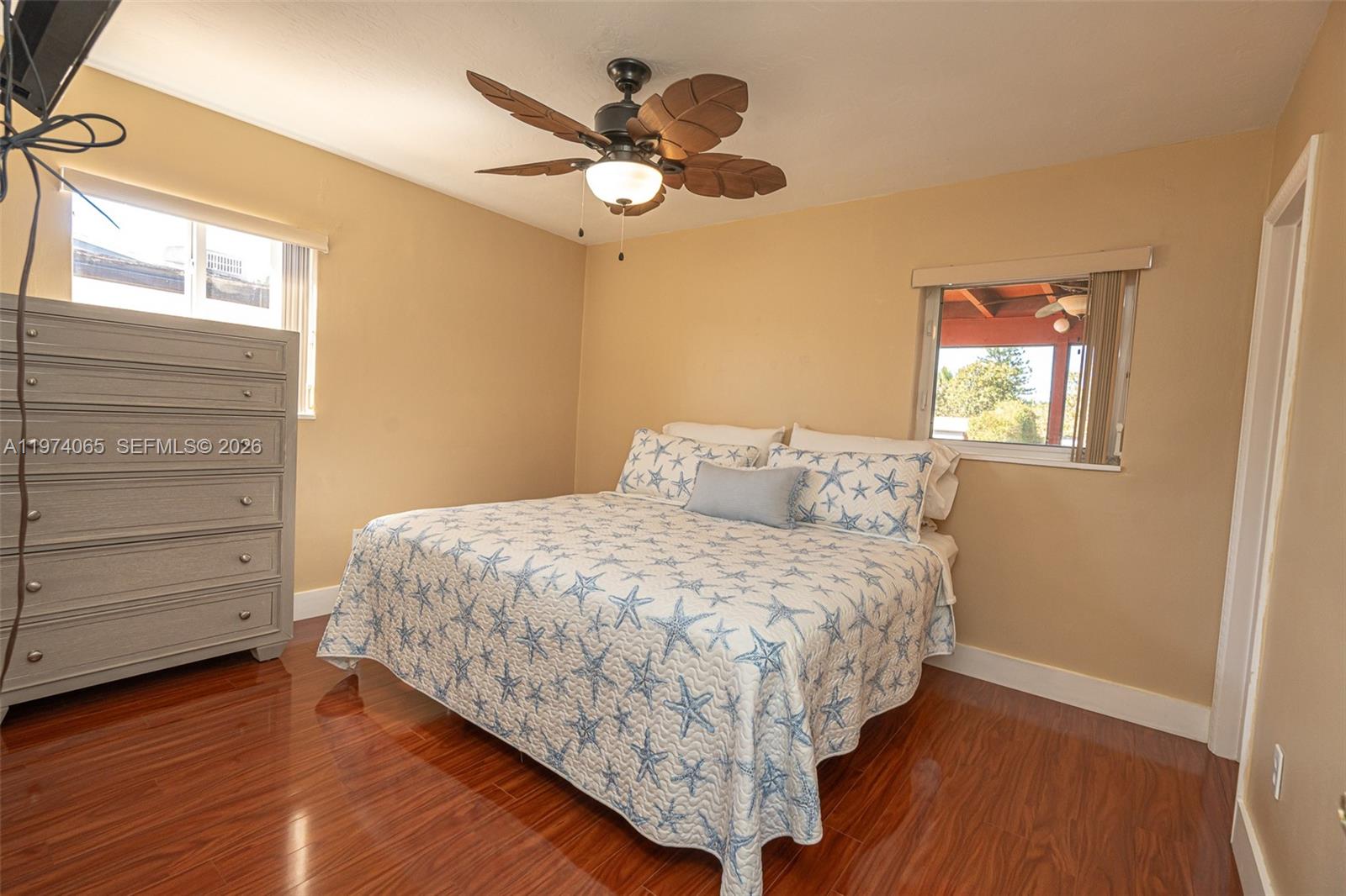 4600 Southwest 104th Avenue Miami, FL 33165 - Photo 19 of 40 a bedroom with a bed chandelier and a window