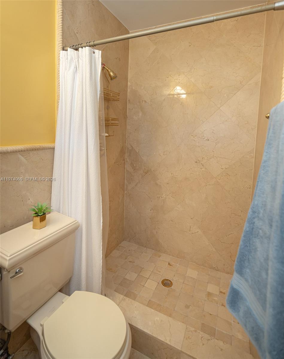 4600 Southwest 104th Avenue Miami, FL 33165 - Photo 20 of 40 a bathroom with a shower a toilet and sink