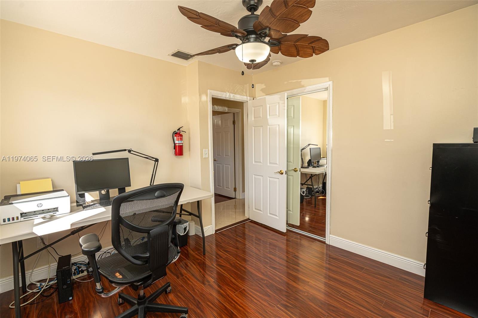 4600 Southwest 104th Avenue Miami, FL 33165 - Photo 26 of 40 a view of a workspace with furniture and a ceiling fan