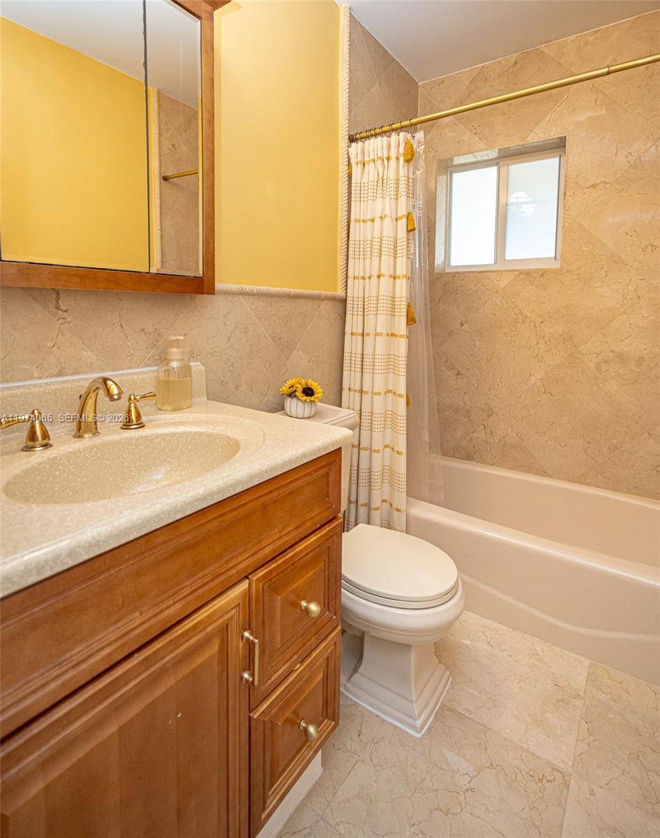 4600 Southwest 104th Avenue Miami, FL 33165 - Photo 28 of 40 a bathroom with a sink a toilet and shower