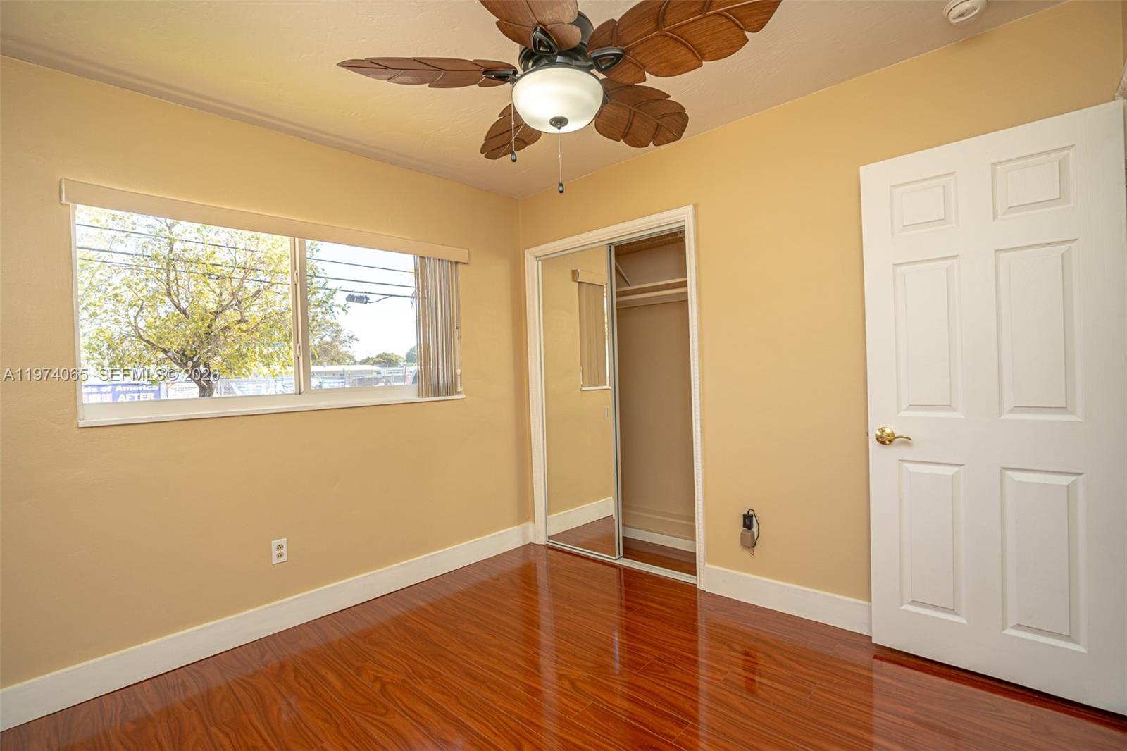 4600 Southwest 104th Avenue Miami, FL 33165 - Photo 29 of 40 a view of an empty room with wooden floor and a window