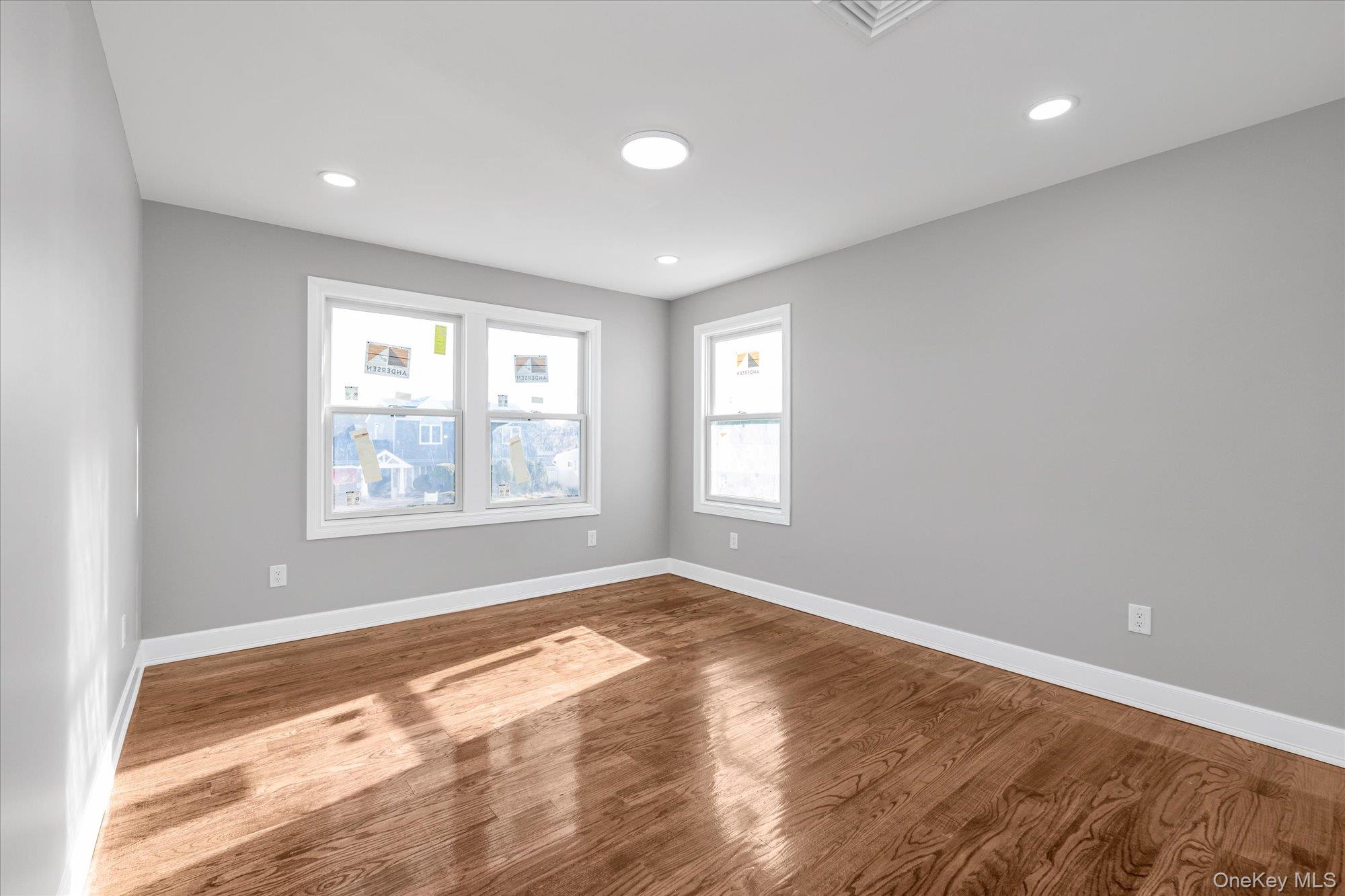 33 Prentice Road Levittown, NY 11756 - Photo 14 of 24 a view of empty room with wooden floor and fan
