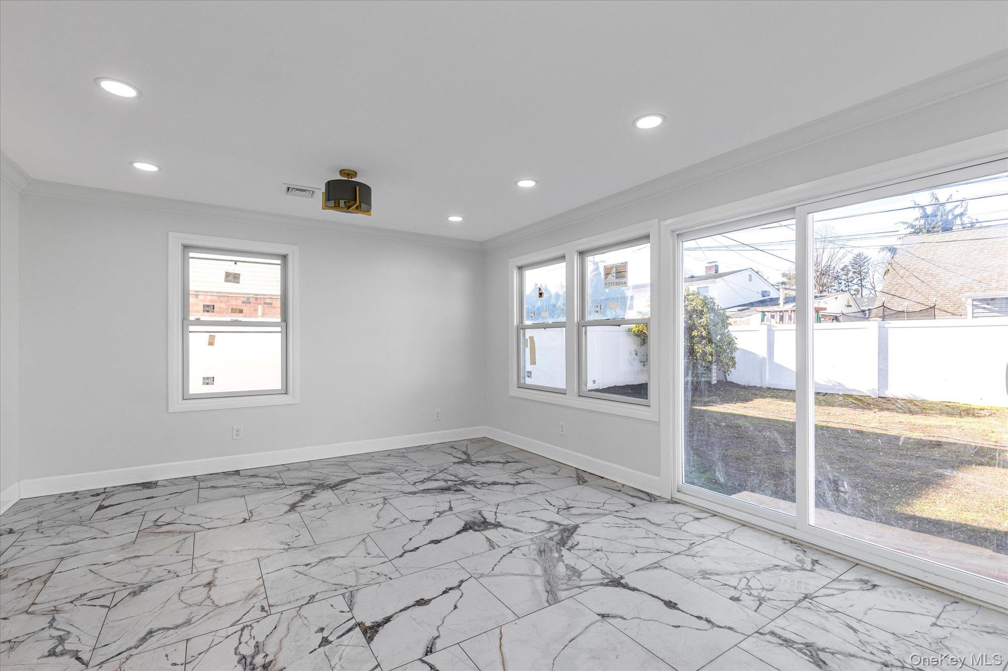 33 Prentice Road Levittown, NY 11756 - Photo 6 of 24 a view of an empty room and window