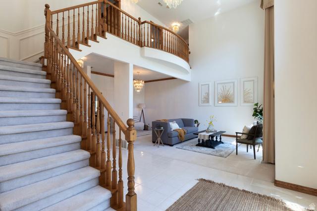 1085 Windsor Drive Provo, UT 84604 - Photo 13 of 83 Stairs with a chandelier, a towering ceiling, and tile patterned floors