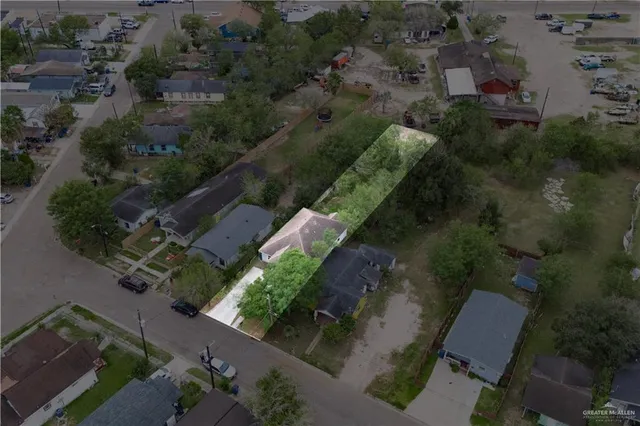 an aerial view of a house with a yard