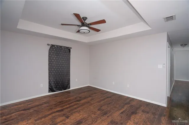 a view of a big room with wooden floor closet and windows