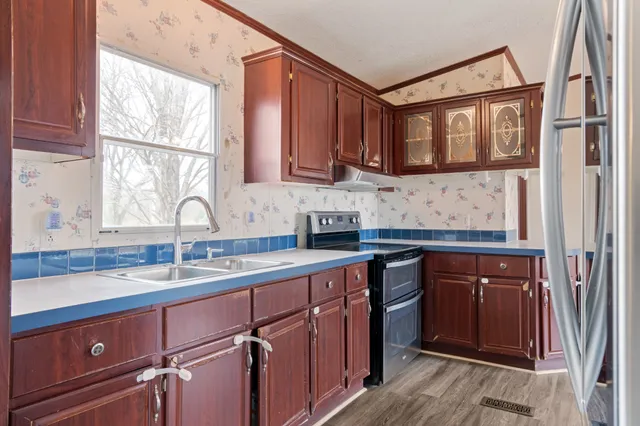 a kitchen with a sink window and cabinets