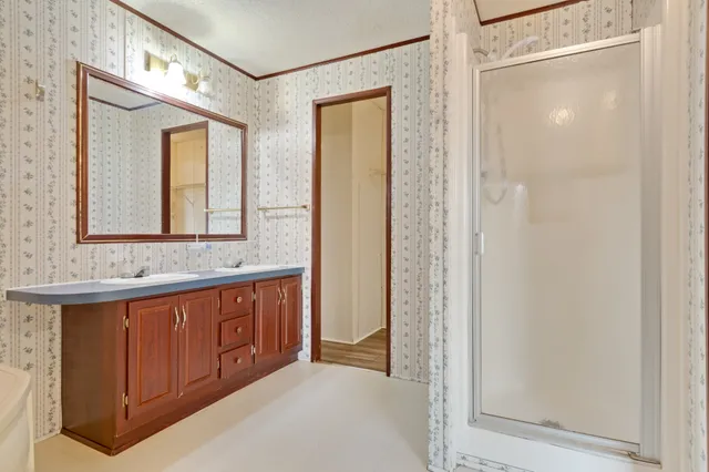 a bathroom with a double vanity sink and a mirror