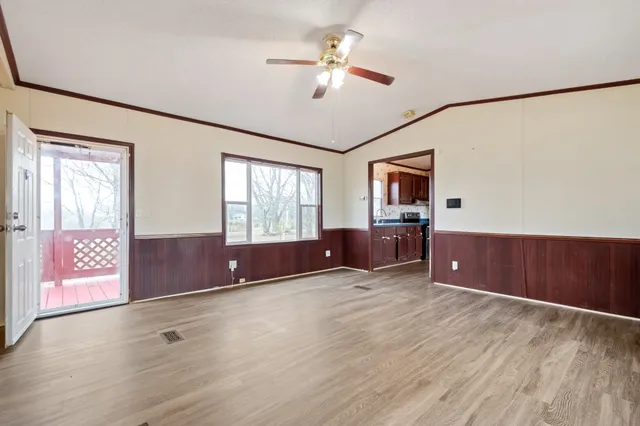 an empty room with windows and cabinet