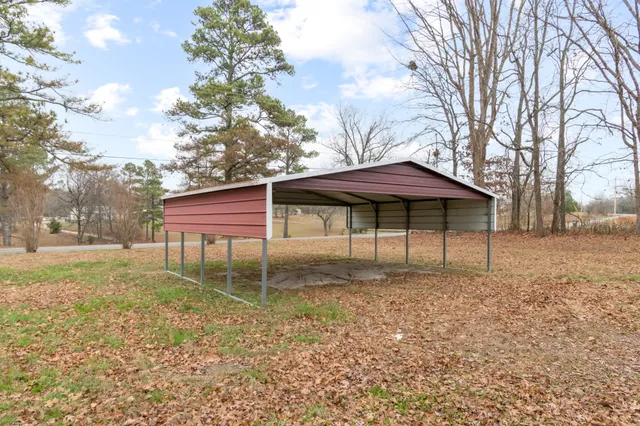 a backyard of a house with table and chairs