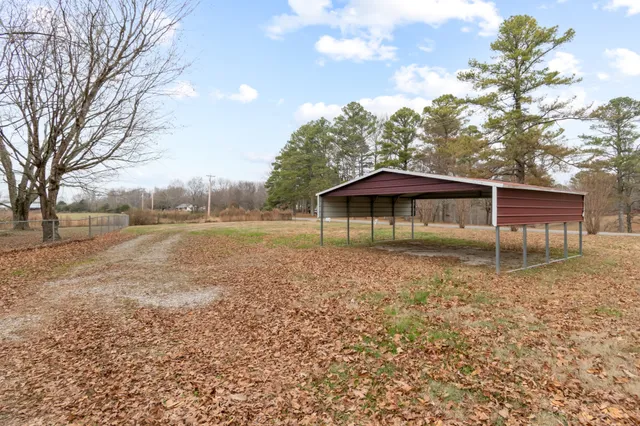 a backyard of a house with table and chairs