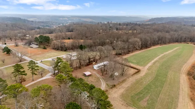 an aerial view of a house with a yard