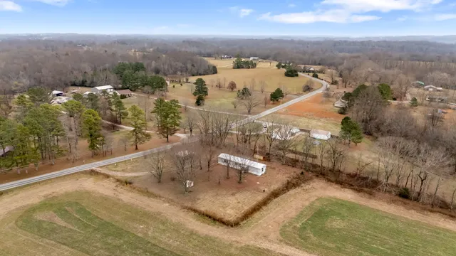 an aerial view of a house with a yard