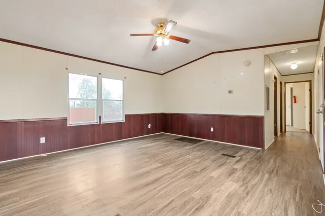 wooden floor in an empty room with a window