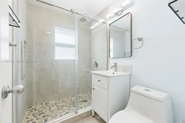 a bathroom with a sink toilet and shower