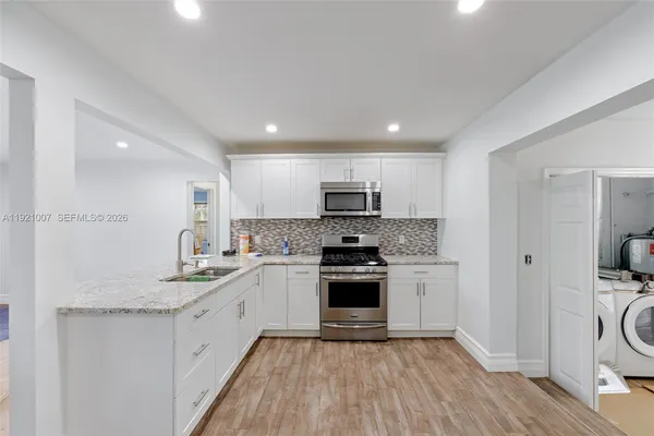 a kitchen with a sink stove and refrigerator