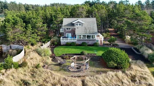 a view of a house with backyard sitting area and garden
