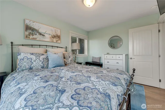 a bed sitting in a bedroom next to a window