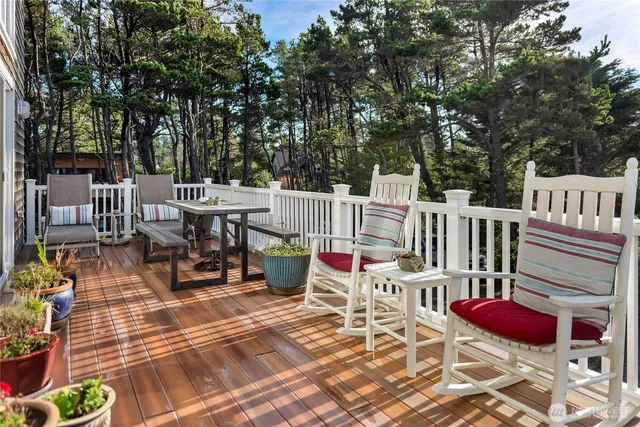 a dining room with stainless steel appliances kitchen island granite countertop a dining table chairs and a oven