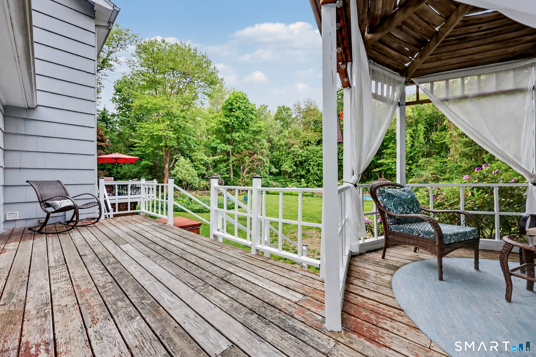 571 Wheeler Road Monroe, CT 06468 - Photo 35 of 40 a balcony with wooden floor table and chairs