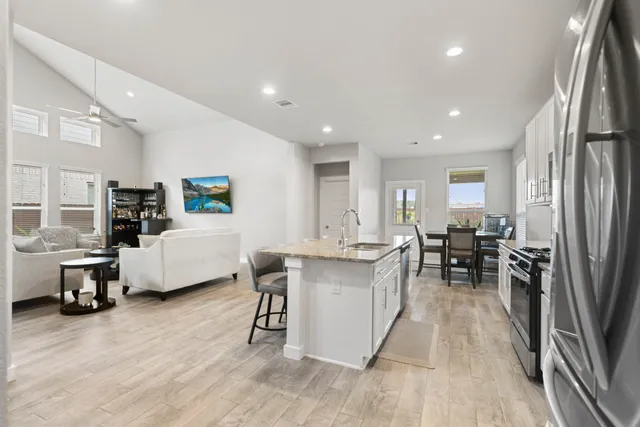 a living room with furniture and kitchen view