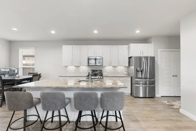 a living room with furniture a rug and a flat screen tv