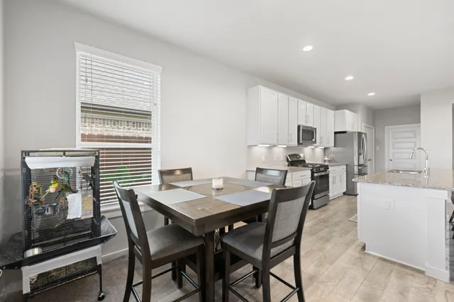 a view of dining room with furniture and wooden floor