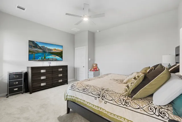 a view of a hallway with furniture and lots of frames on wall
