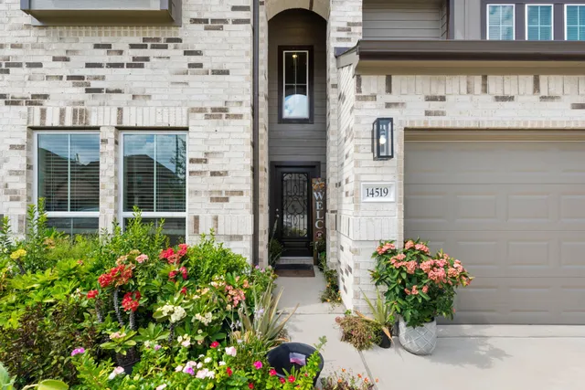a front view of a house with flowers
